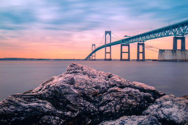 istock Dramatic sunset over Claiborne Pell Newport Bridge and glacial beach rocks 1503043671