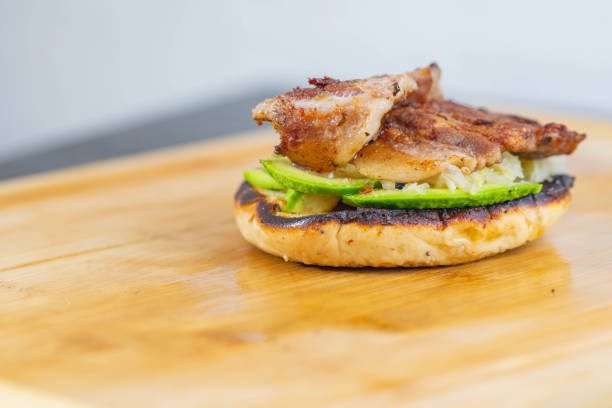 Breakfast sandwich everything bagel with pork egg and avocado