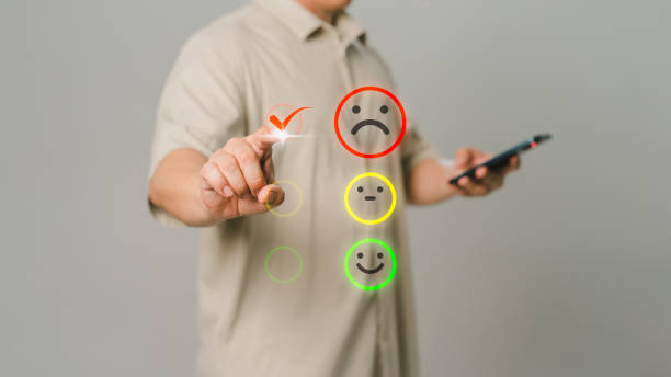 istock Client hand is touching virtual screen on the angry emotion face. Assessment testimonial review for dislike service and low quality. Business service concept of customer experience dissatisfaction. 1503047648