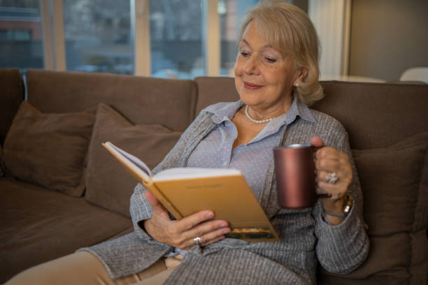 istock Woman relaxing and reading a book 1503060345