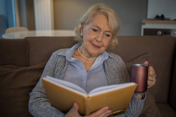 istock Woman relaxing and reading a book 1503060347