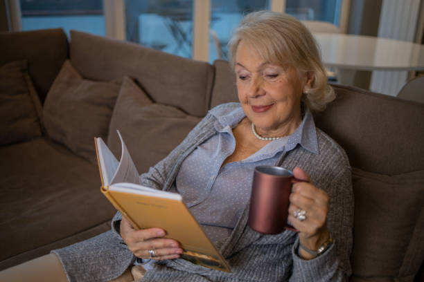 istock Woman relaxing and reading a book 1503060348