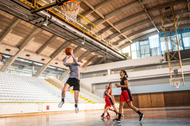 istock Basketball female team throwing ball into hoop 1503060546