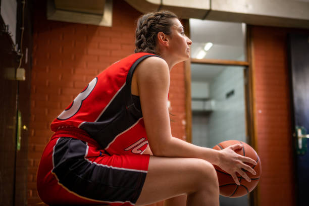 istock Basketball player holding ball in locker room 1503060552