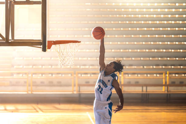 istock Basketball player throwing ball through hoop 1503060579