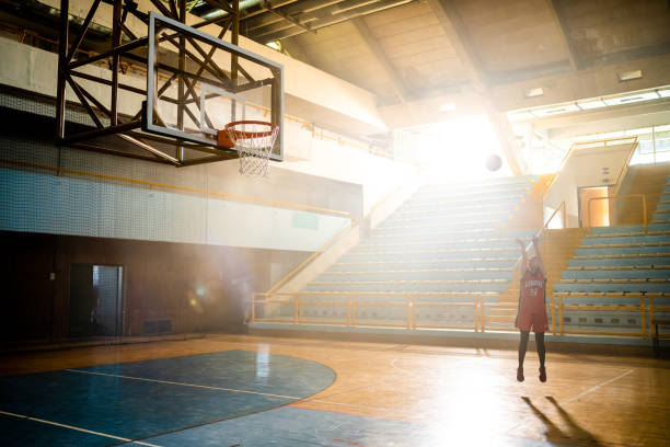 istock Basketball player jumping and throwing ball 1503060584