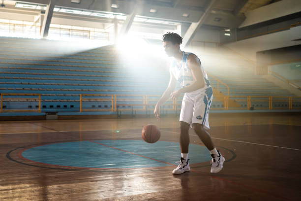 istock Basketball player dribbling ball at court 1503060589