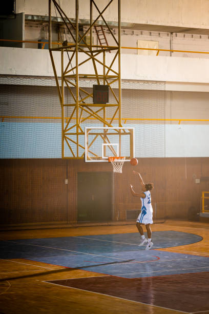 istock Basketball player jumping and throwing ball 1503060590
