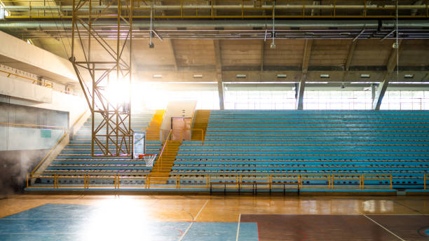 Empty indoors basketball court at day time with sunlight