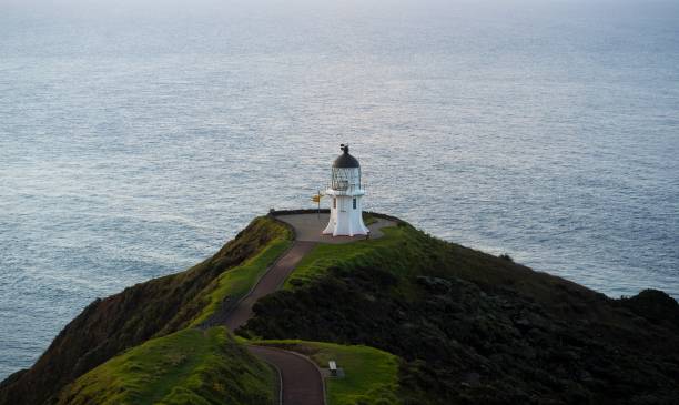 istock Panoramic view of historic white lighthouse landmark perched on oceanside clifftop Cape Reinga Northland New Zealand 1503064271