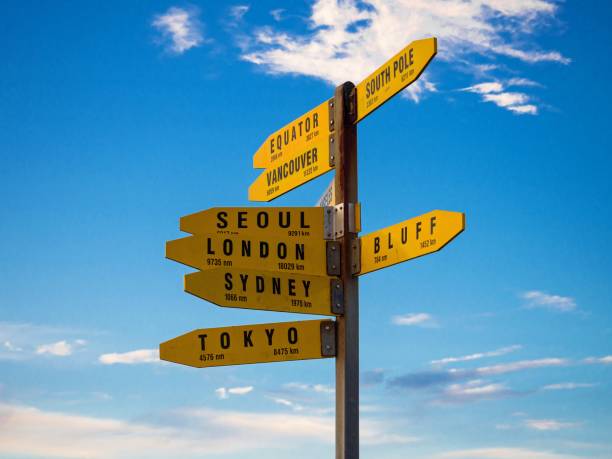 istock Yellow signpost information pole showing world destinations and direction arrows with blue sky, Cape Reinga New Zealand 1503064292