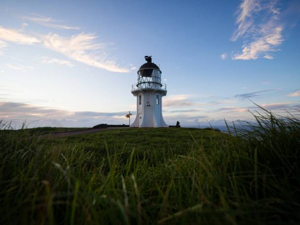 istock Panoramic view of historic white lighthouse landmark perched on oceanside clifftop Cape Reinga Northland New Zealand 1503064295