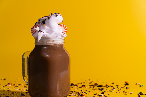 Chocolate Drink in Mason Jar with Whipped Cream, Sprinkles, and Peppermint Candies