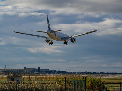 Barcelona- Spain: December 16, 2022: Emirates plane landing at Barcelona airport.