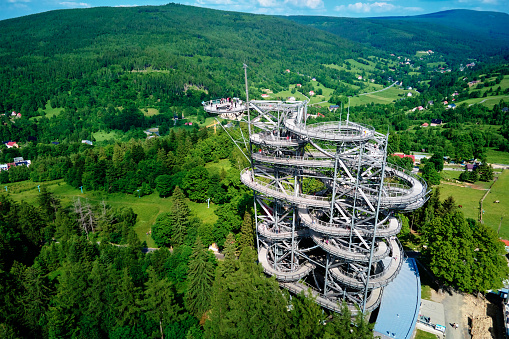 Sky Walk observation tower in Sweradow Zdroj, Poland. Tourist attraction in montains, aerial view. Panoramic view of nature landscape with green forest