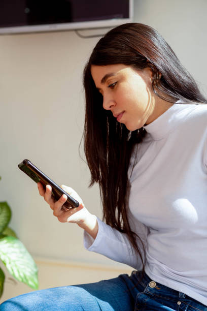 istock send a text message, technological device used for communication, young woman with long straight hair 1503106655