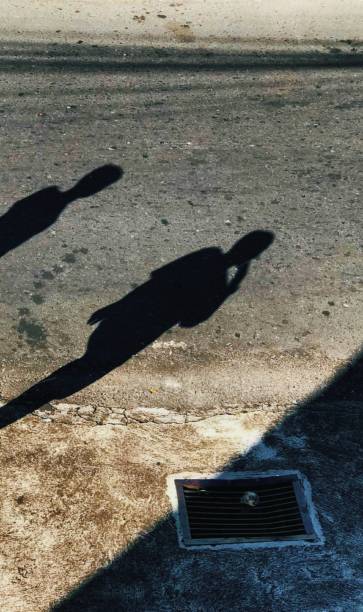 istock shadows of people on the street 1503107749