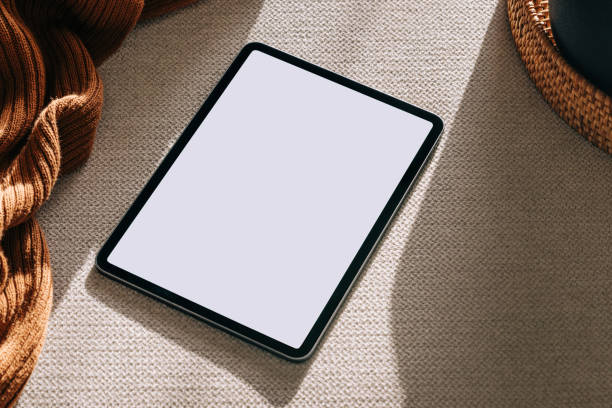 istock Tablet on the sofa in natural light. Device mock-up in neutral tones 1503110378