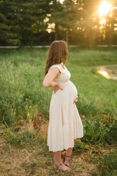 istock Expectant pregnant mother looking away at nature while holding belly 1503128412