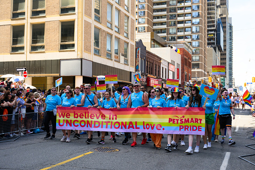 Toronto, Canada - June 25, 2023: The team from Petsmart, a privately held American chain of pet superstores, celebrates at the Pride Toronto Parade, organized by Pride Toronto, a non-profit organization.