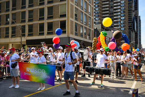 Toronto, Canada - June 25, 2023: Team RW & CO. , a fashion apparel company, celebrates at the Pride Toronto Parade , organized by Pride Toronto, a non-profit organization.