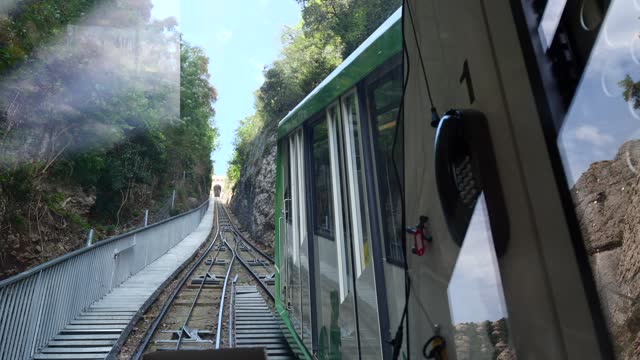 Tourists ride the funicular train in Montserrat near Barcelona, Spain