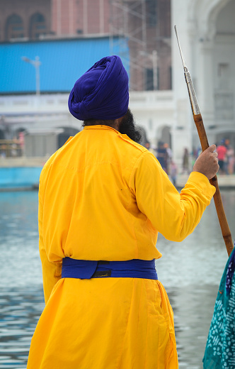 Amritsar, India - Jul 25, 2015. Sikh guard in Golden Temple (Harmandir Sahib) in Amritsar, Punjab, India. Golden Temple is the holiest Gurdwara of Sikhism.