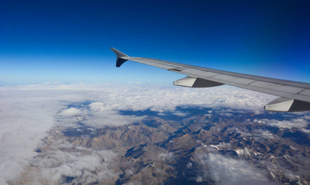 istock View from airplane to mountains and clouds 1503168791