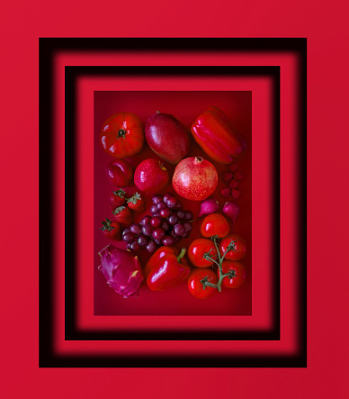 Looking down on monochrome red fruits and vegetables