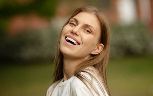 istock Woman smiling with perfect smile and white teeth looking at camera. 1503195506