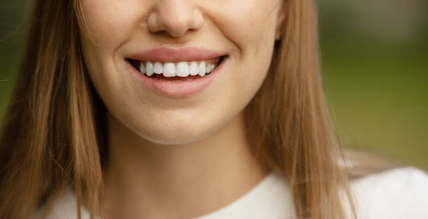 istock Woman smiling with perfect smile and white teeth looking at camera. 1503195507