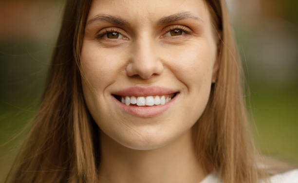 istock Woman smiling with perfect smile and white teeth looking at camera. 1503195508