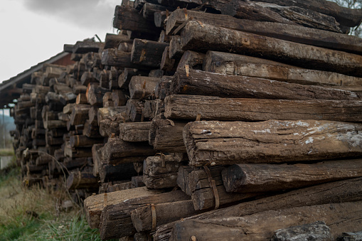 Wall of stacked wood logs for background.