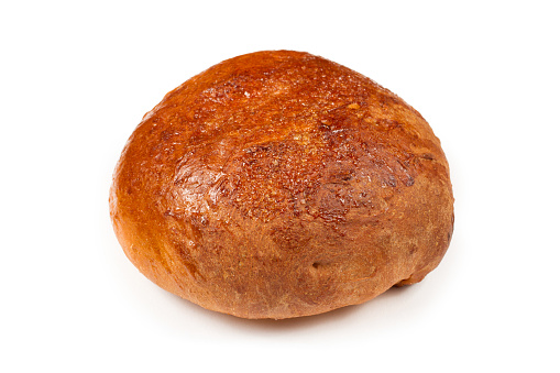 Round loaf of bread on a white background. Sweet bun on a white background. Bakery products close-up.