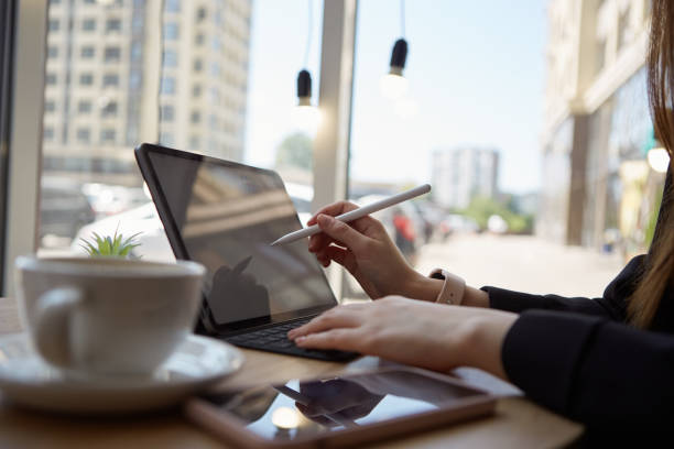 istock Freelance graphic designer drawing an illustration on a tablet computer in a cafe. Professional illustrator female working in a restaurant 1503204561