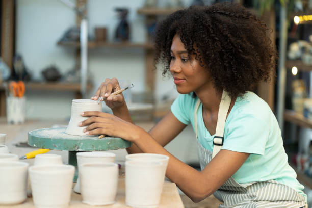 istock Handcrafted Elegance: Girl Showcasing her Clay Artistry in the Ceramic Studio 1503206185