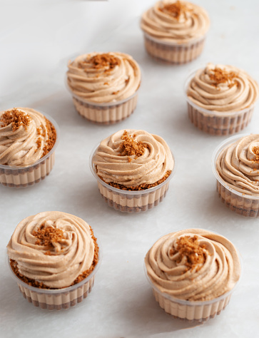 Chocolate and Coffee Cupcakes, Delicious Dessert, Birthday Cupcakes, Soft Cupcakes spread with Brown Sugar and Crunches.