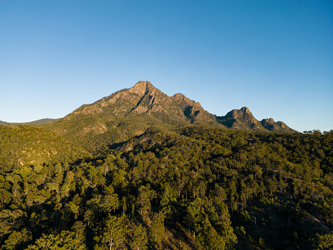 Elevated drone shot of early morning light on Mt Barney in the Scenic Rim, Queensland, Australia