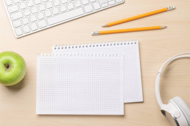istock Top view of blank notepad, keyboard, headphones and apple 1503213419