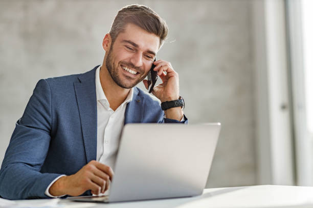 istock Happy businessman talking on cell phone while working on laptop in the office. 1503214529