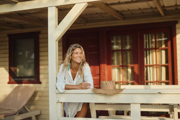 istock Young happy woman enjoying while day dreaming on a patio. 1503214832