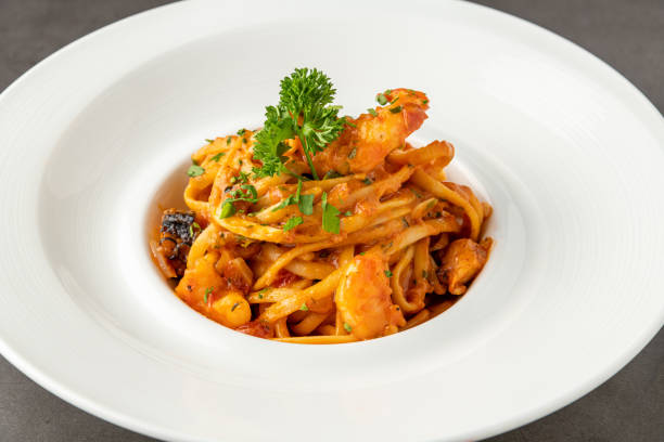 istock Shrimp spaghetti on white porcelain plate on black stone table 1503219785