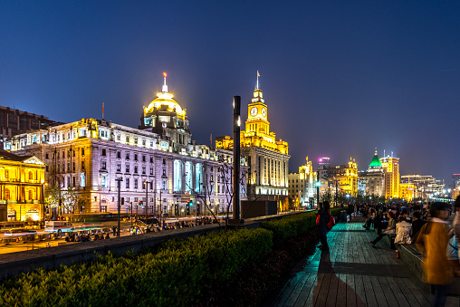 Chinese people stalling on the Bund in Shanghai, China after sunset.