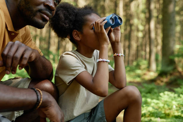 istock Little girl looking through binoculars during hiking 1503225292