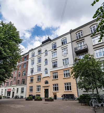 Copenhagen, Denmark - June 25, 2023: Old apartment building from around the turn of the last century in the colorful, multi-ethnical district, Nørrebro, in Copenhagen.