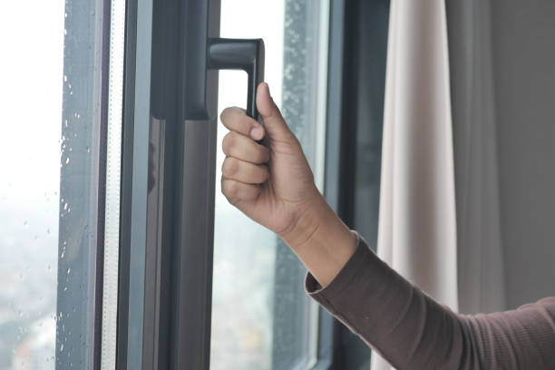 istock Young woman opening window in flat 1503228073