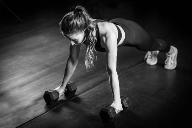 istock Woman Doing Push-ups with dumbbells 1503228097
