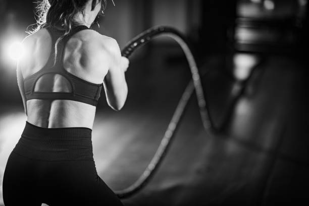 istock Agility training, woman exercising with rope in a gym. 1503228198