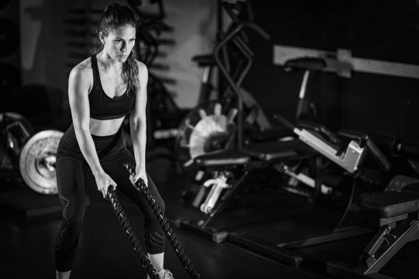 istock Agility training, woman exercising with rope in a gym. 1503228201