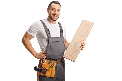 Carpenter holding a wooden floor beam isolated on white background